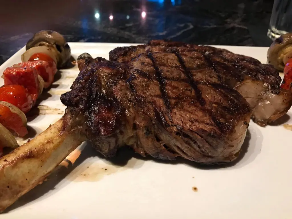 A steak and kabob on the grill.